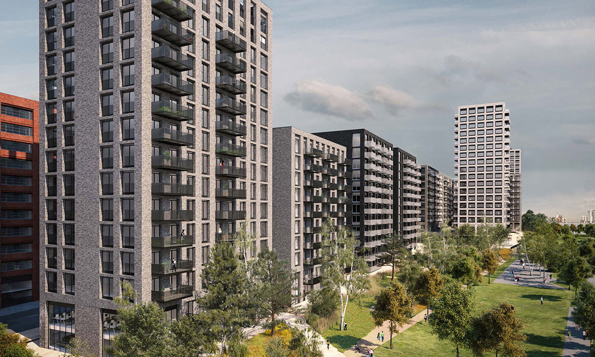 Modern residential buildings with balconies and landscaped green spaces in an urban setting.